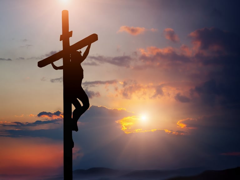 Jesus Christ crucified on the cross at sunset